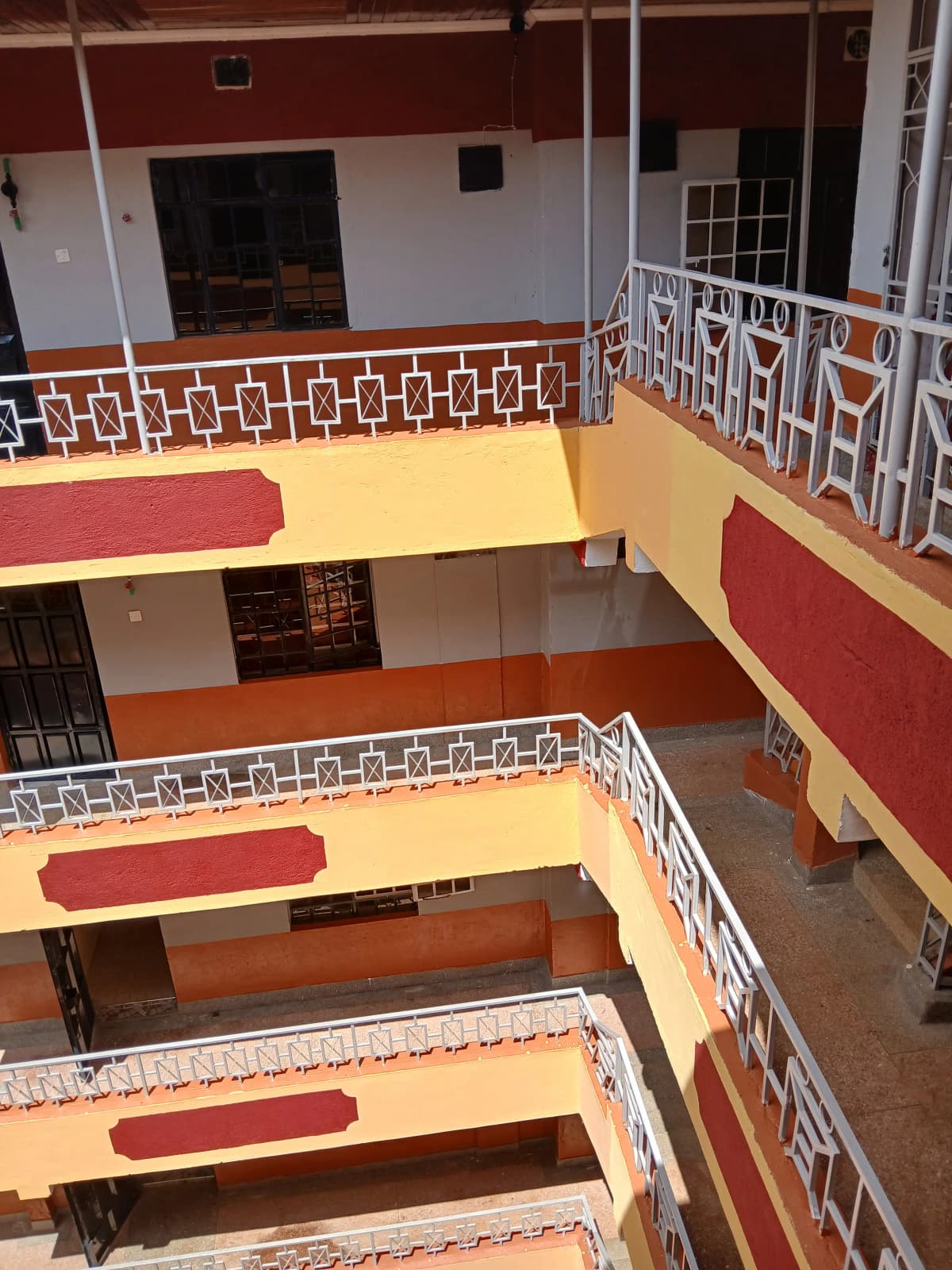 Multi-level building interior with geometric railings and colored walls