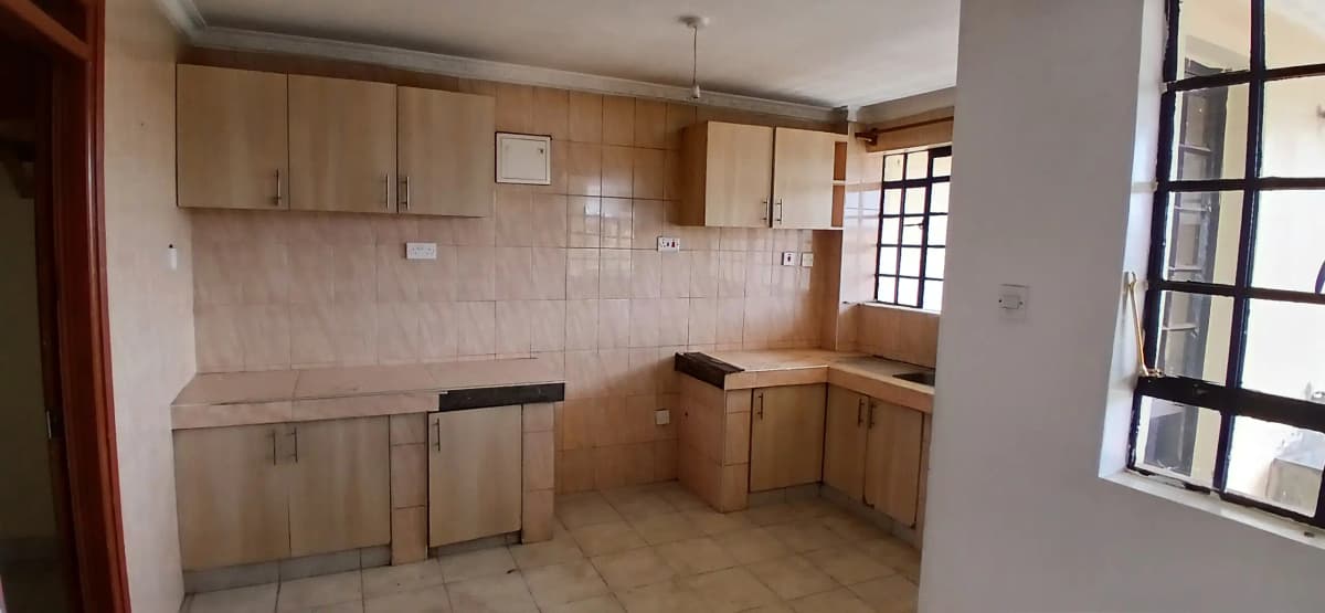 Spacious kitchen with wooden cabinets and tiled backsplash