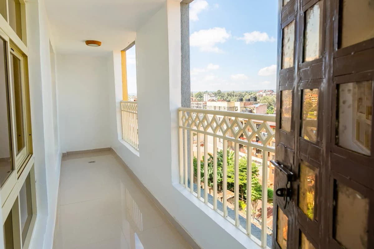 Spacious balcony with city skyline views and safety railing