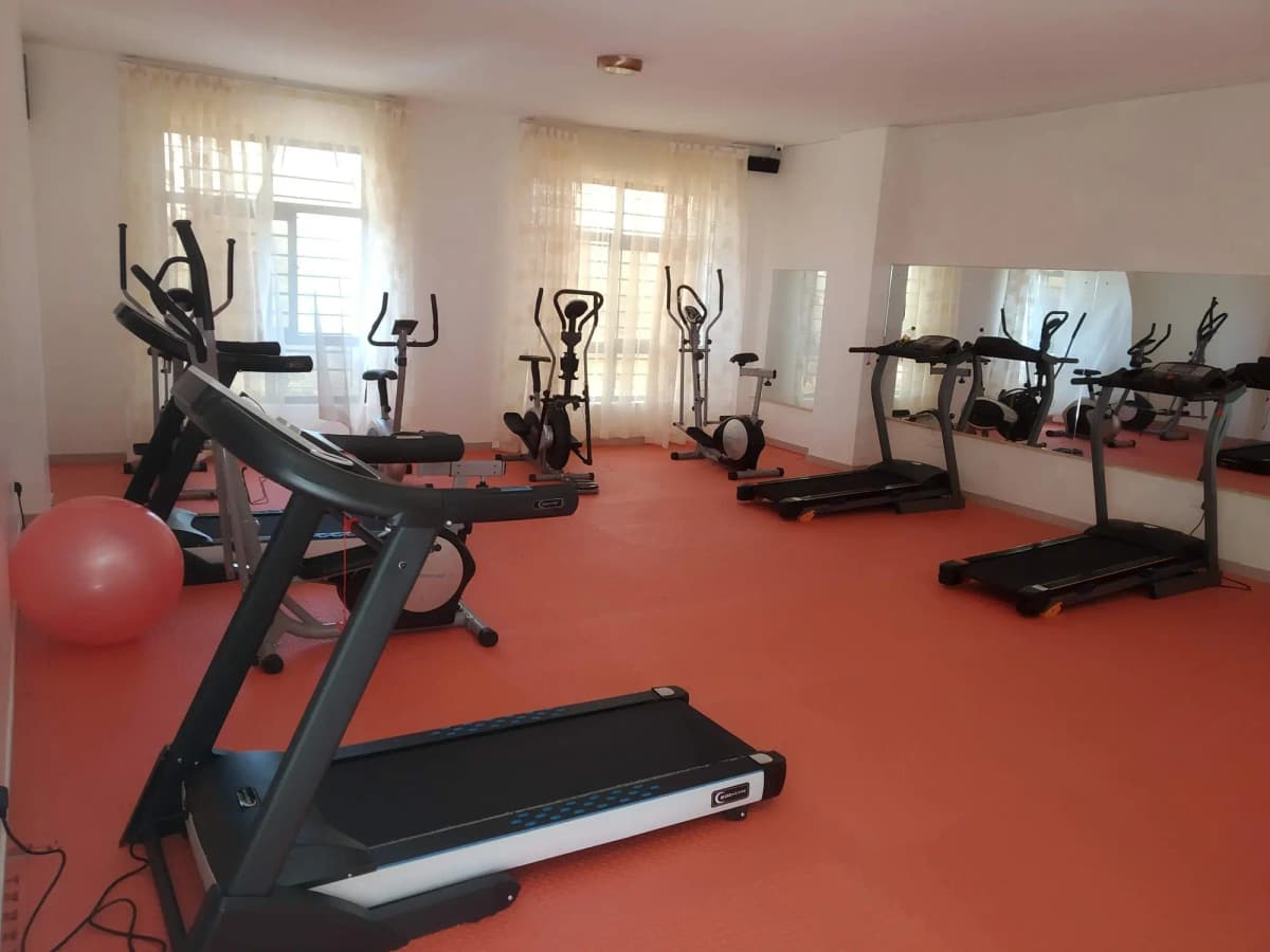 Dedicated fitness room with treadmills, exercise bikes, equipment