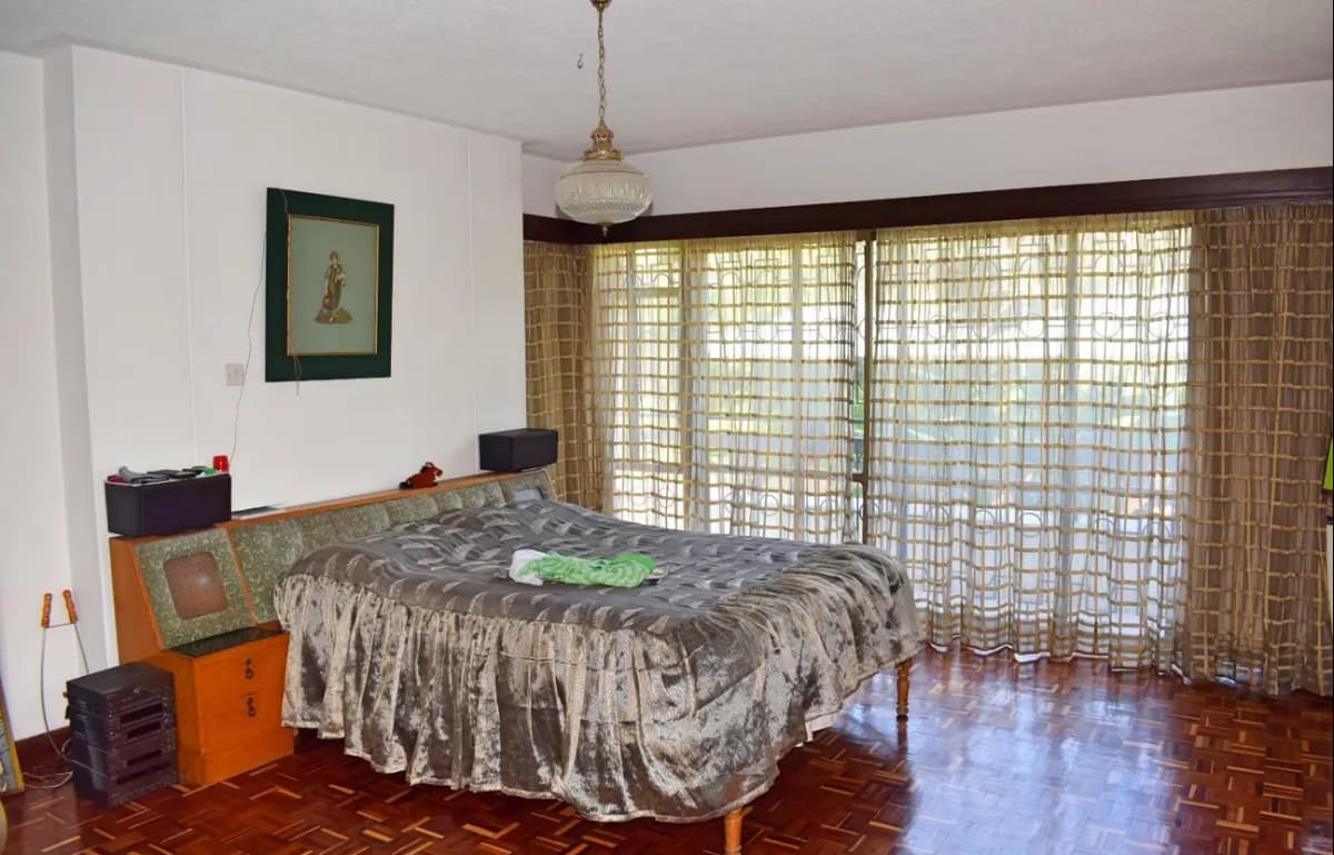 Master bedroom with wooden floors and glass balcony doors