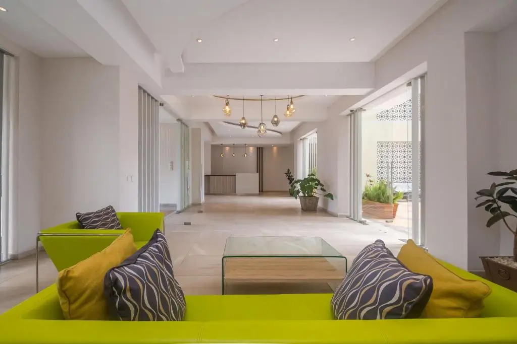 Modern open-plan living area with lime-green seating and natural light