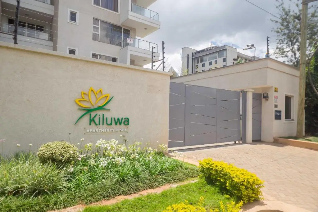 Compound entrance with Kiluwa Apartments branding and landscaped gardens