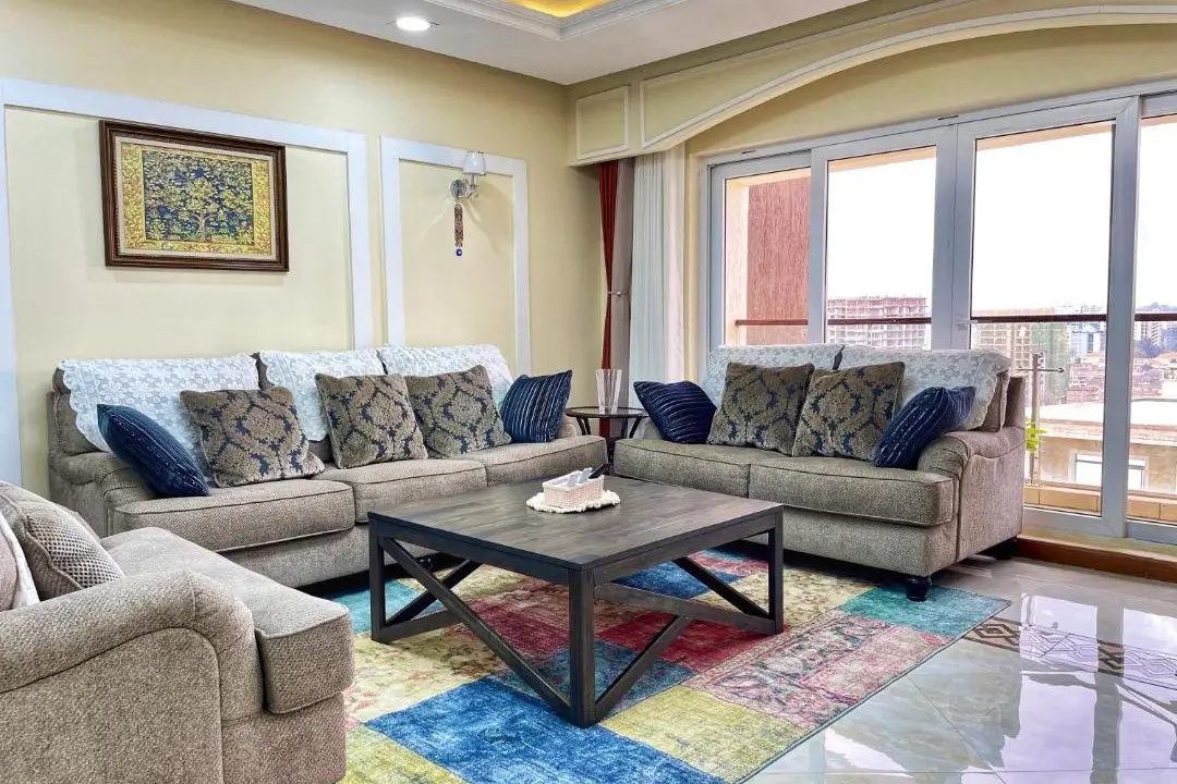 Spacious living room with sectional sofas and city views