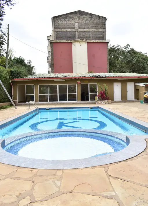 Swimming pool with jacuzzi feature and paved deck area
