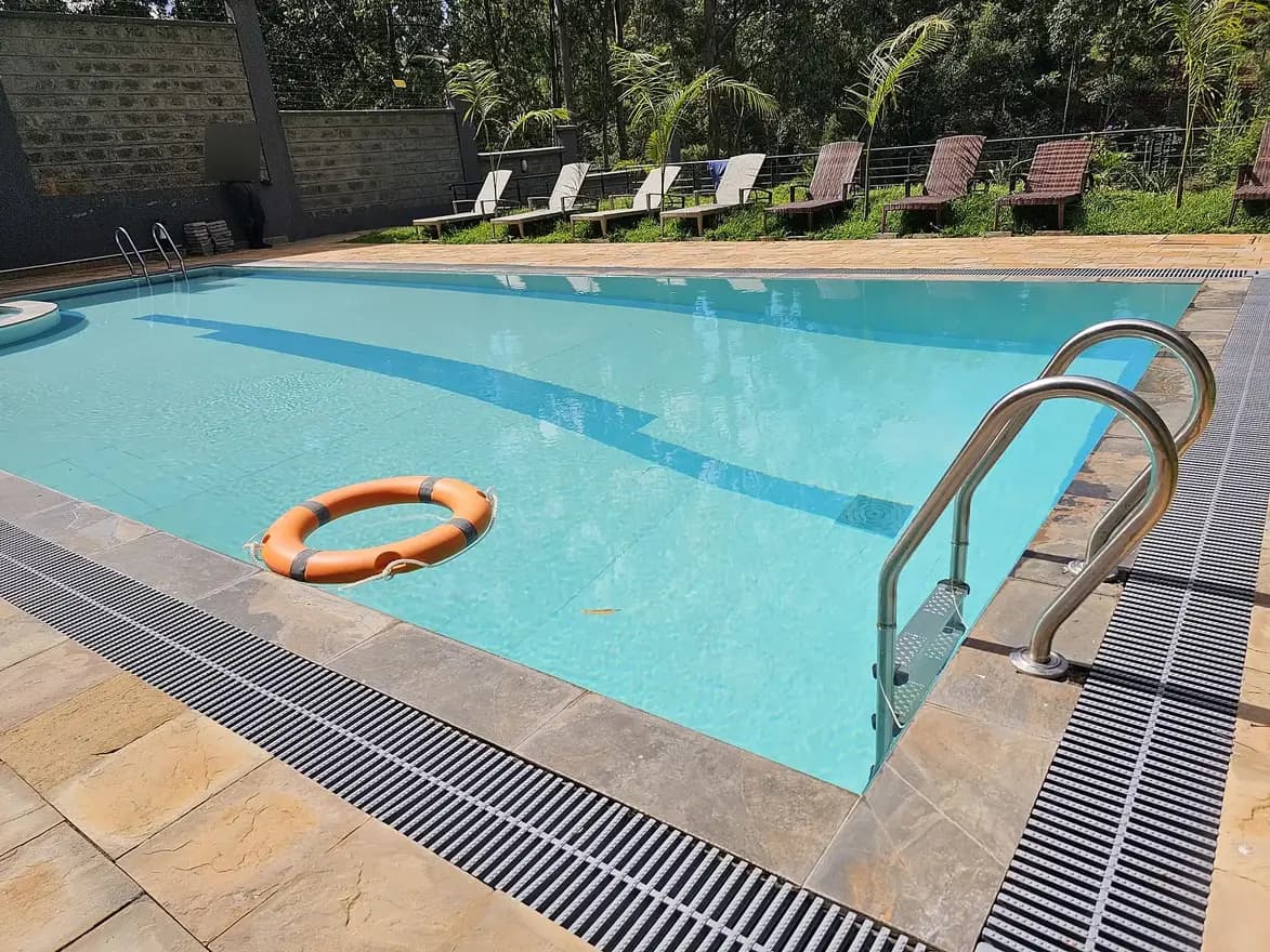 Olympic-length swimming pool with lane dividers and lounge area
