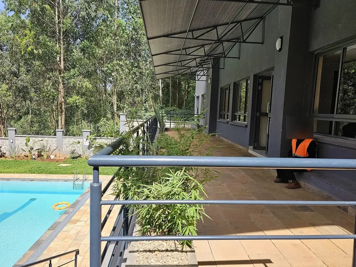 Covered balcony with pool view and garden landscaping