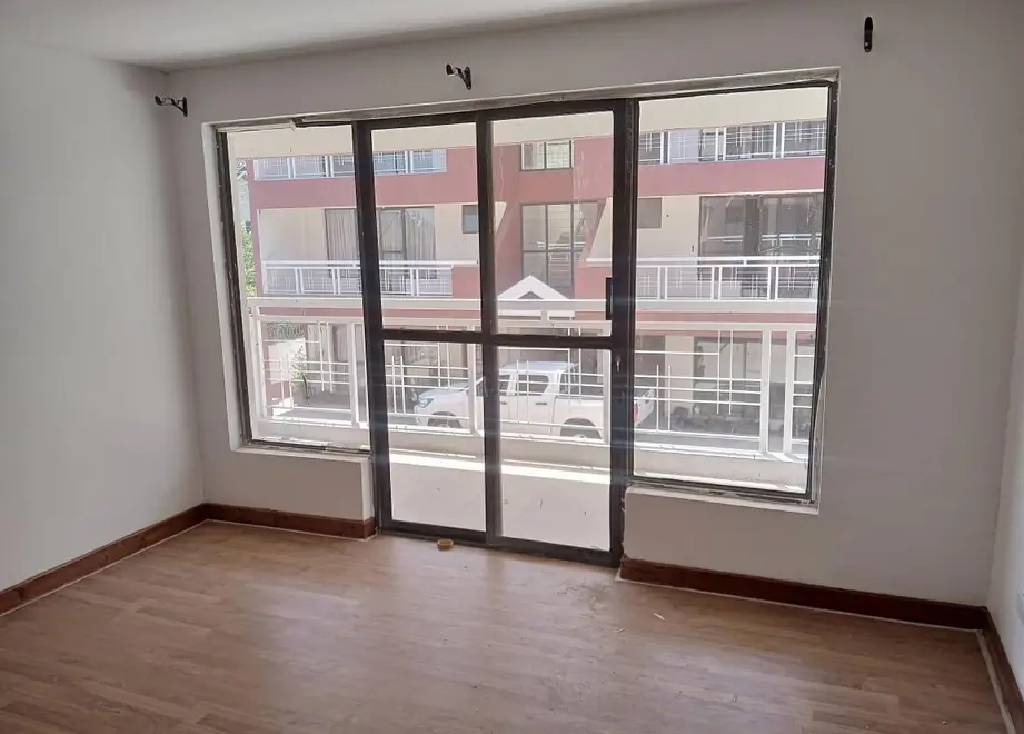 Interior view of adjacent residential buildings through large windows