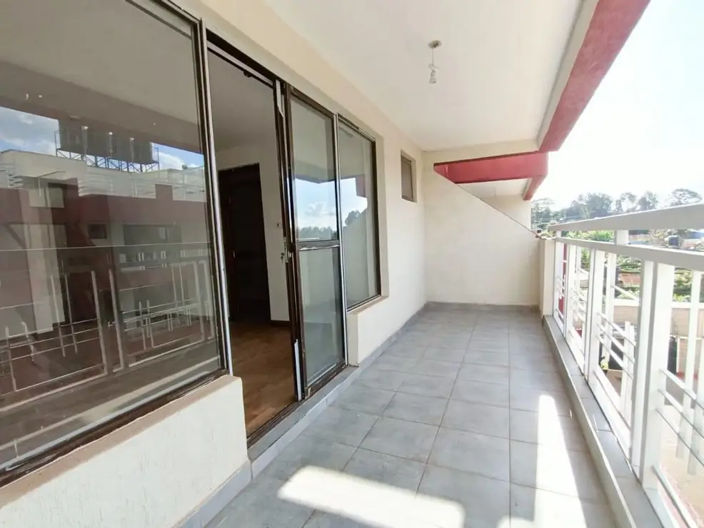 Spacious balcony with sliding glass doors and city outlook