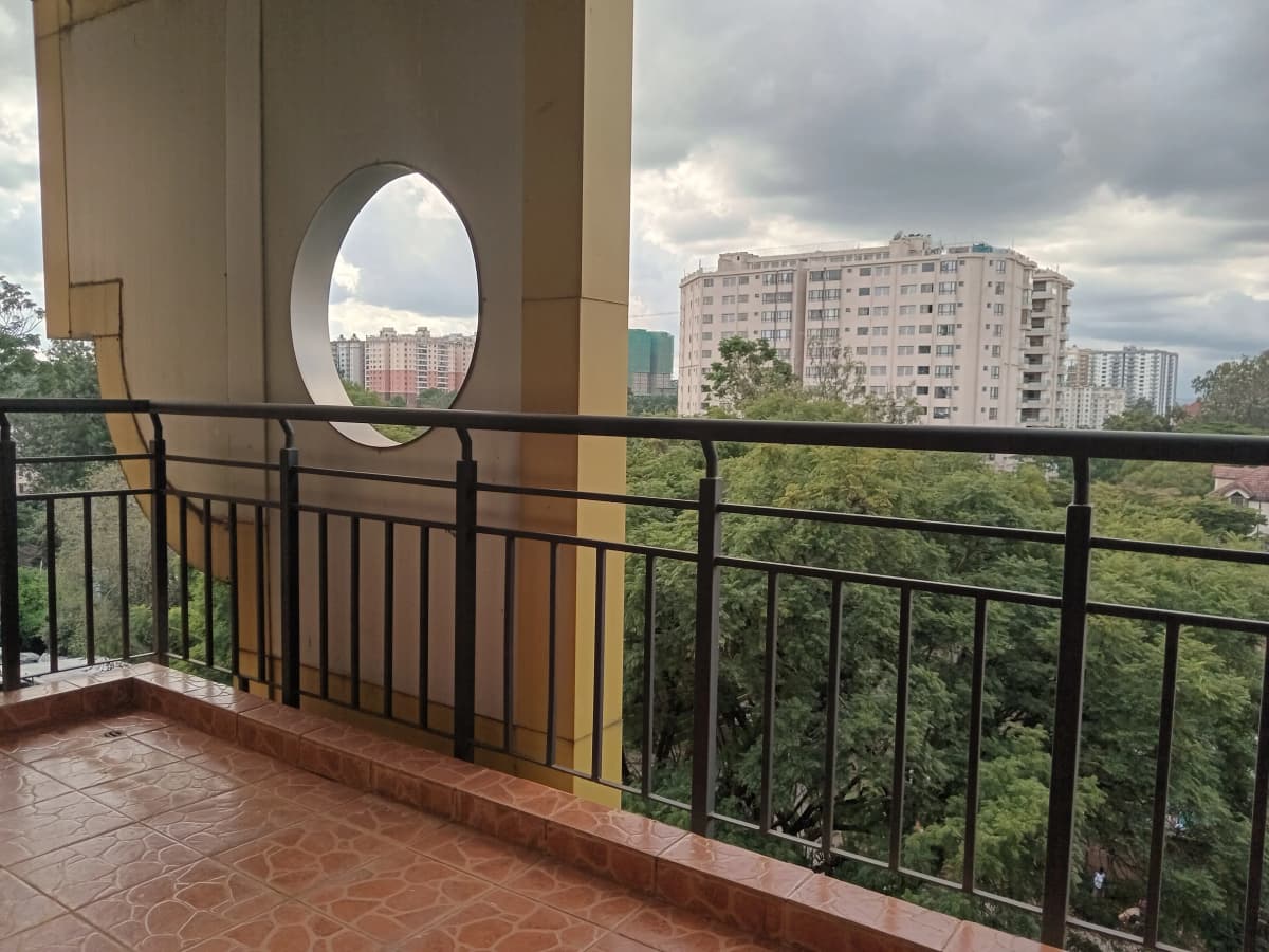 Elevated balcony with city skyline and residential tower views