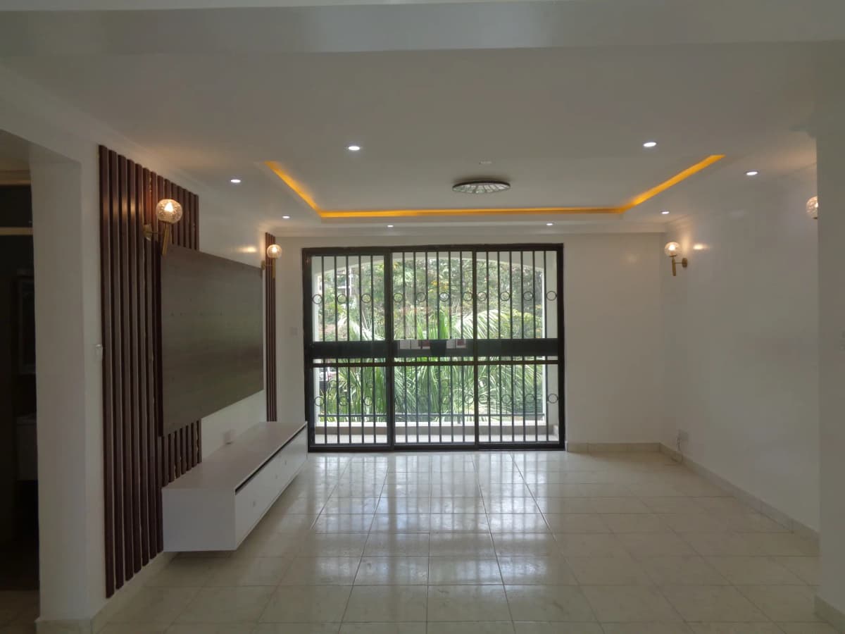 Spacious living room with ambient lighting and large barred windows