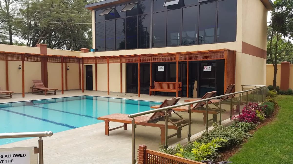 Resort-style swimming pool with loungers and landscaped grounds