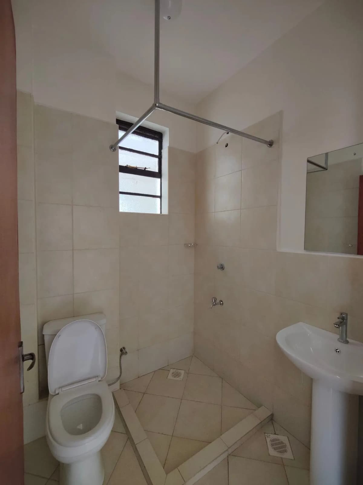 Clean bathroom with toilet, pedestal sink, and shower enclosure