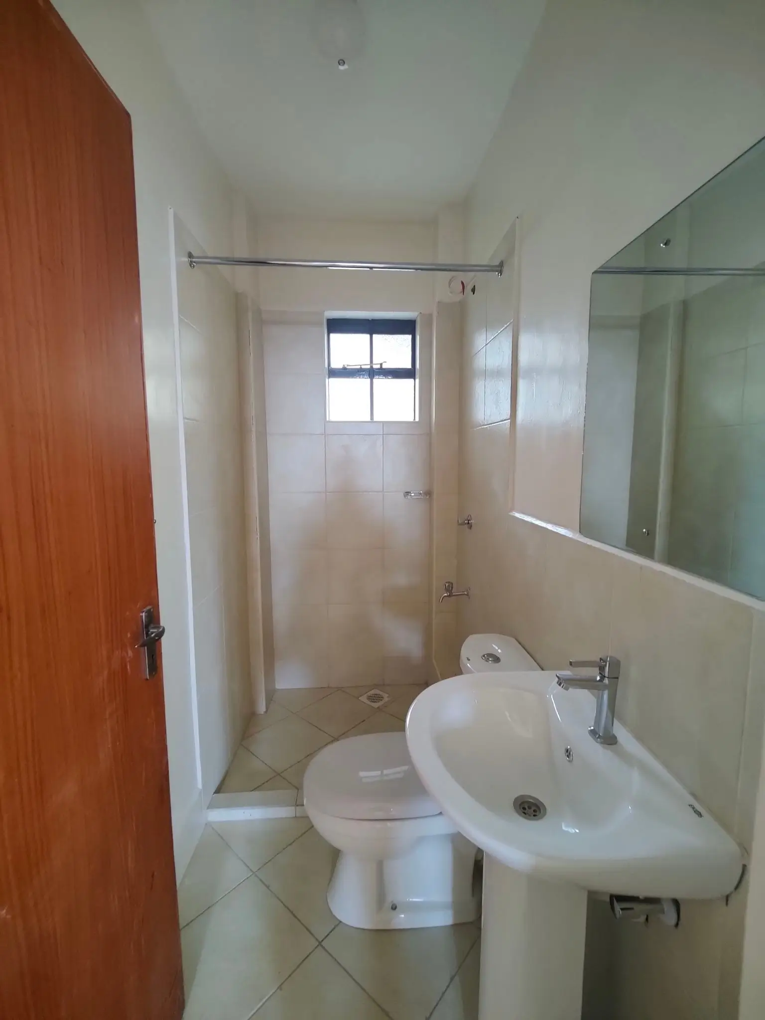 Compact bathroom with pedestal sink and shower enclosure