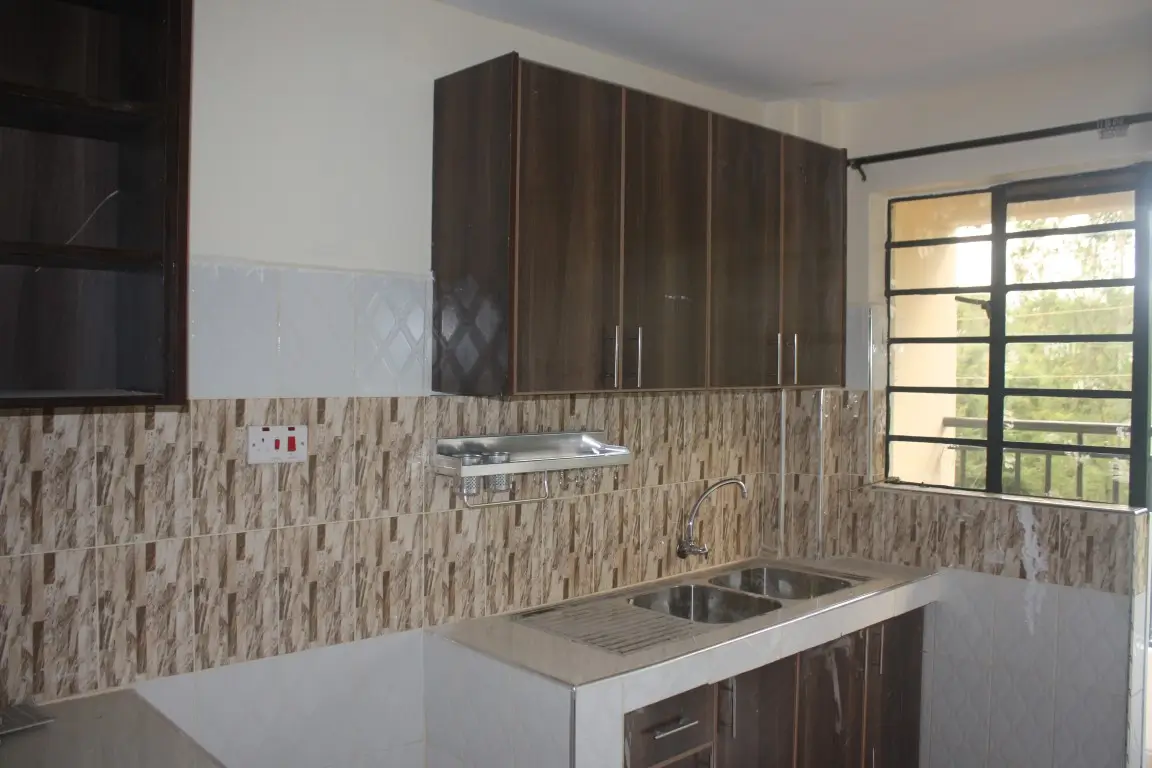 Modern kitchen with dark cabinetry and textured tile backsplash