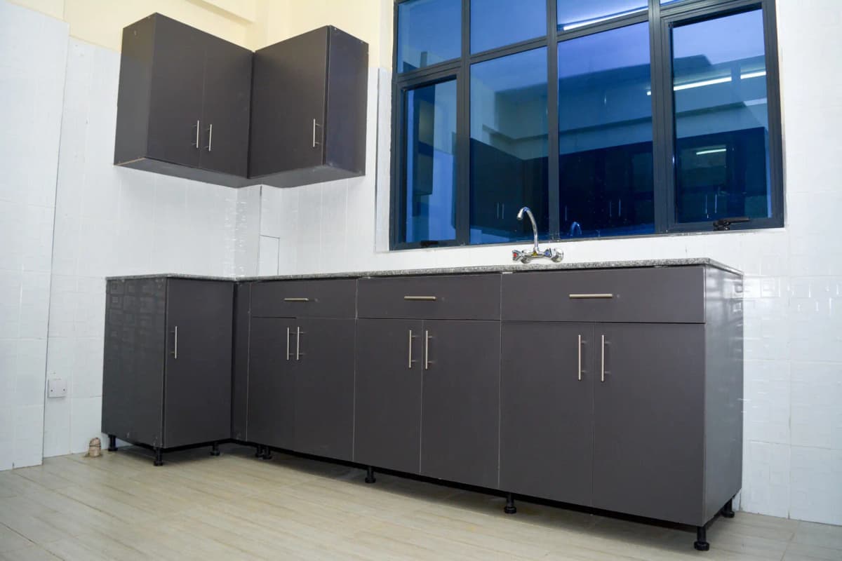 Modern kitchen with dark cabinetry and large window views