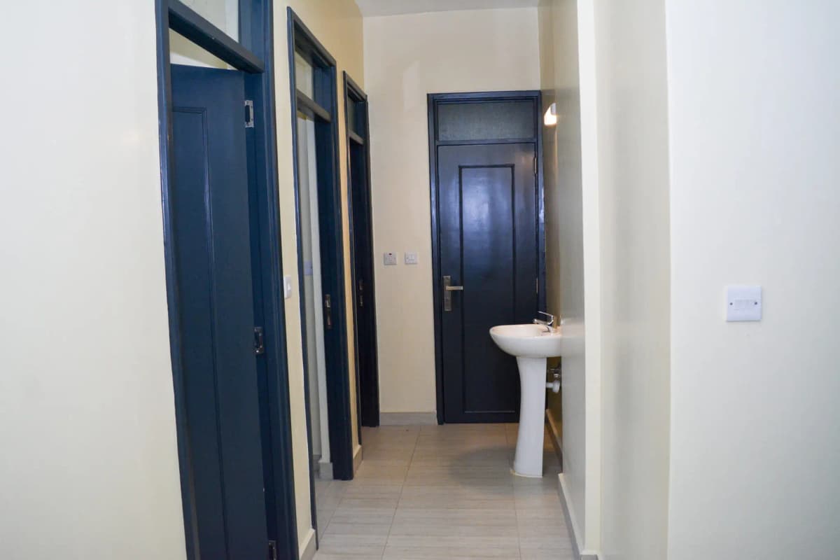 Hallway with dark blue doors and white sink fixture