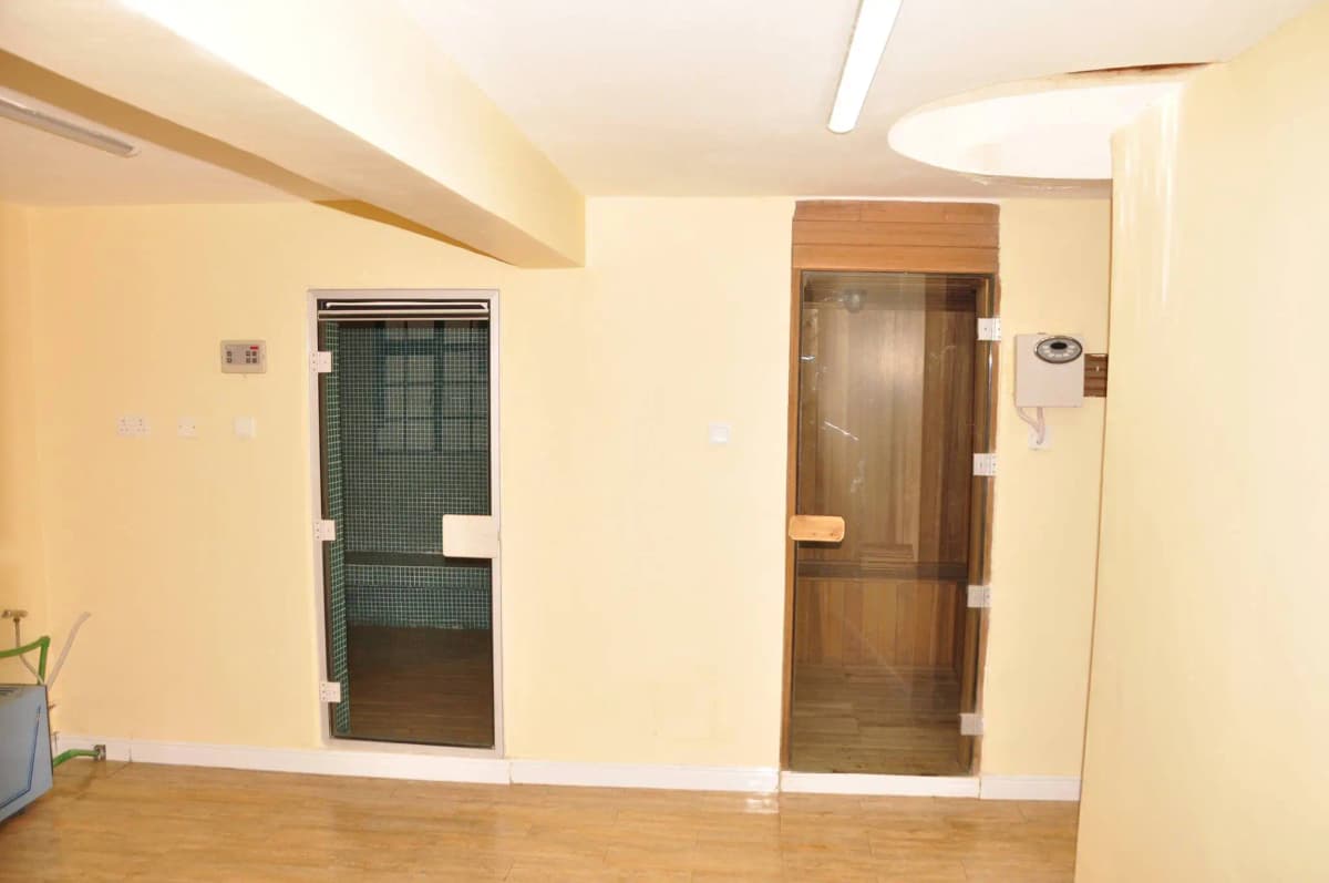 Empty corridor with wooden doors and tiled flooring