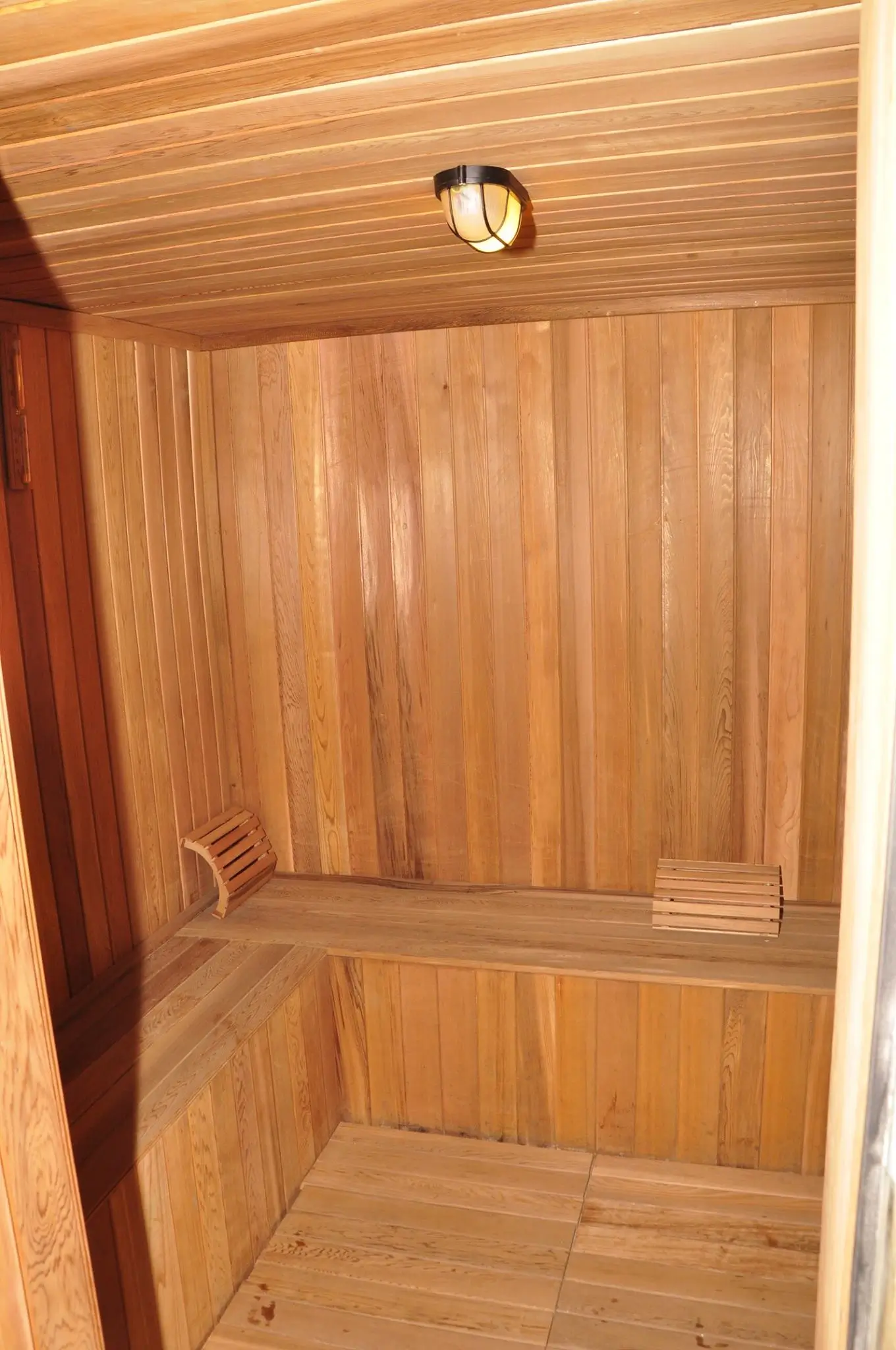 Wooden sauna or steam room interior with bench seating