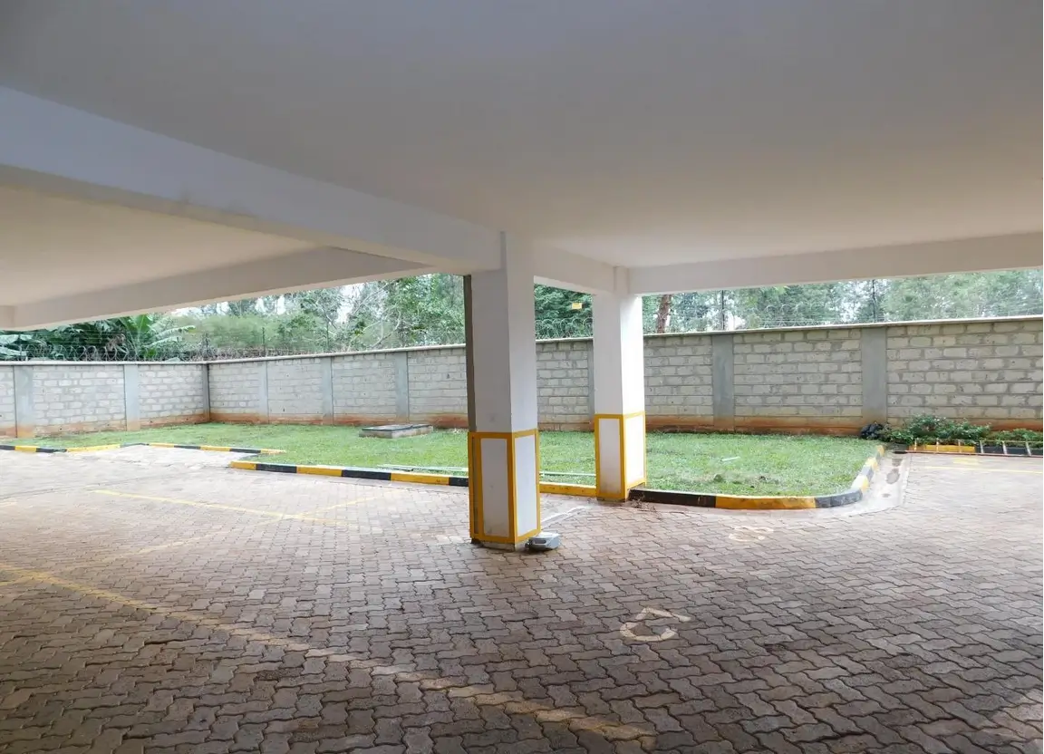 Covered parking area with brick paving and support columns