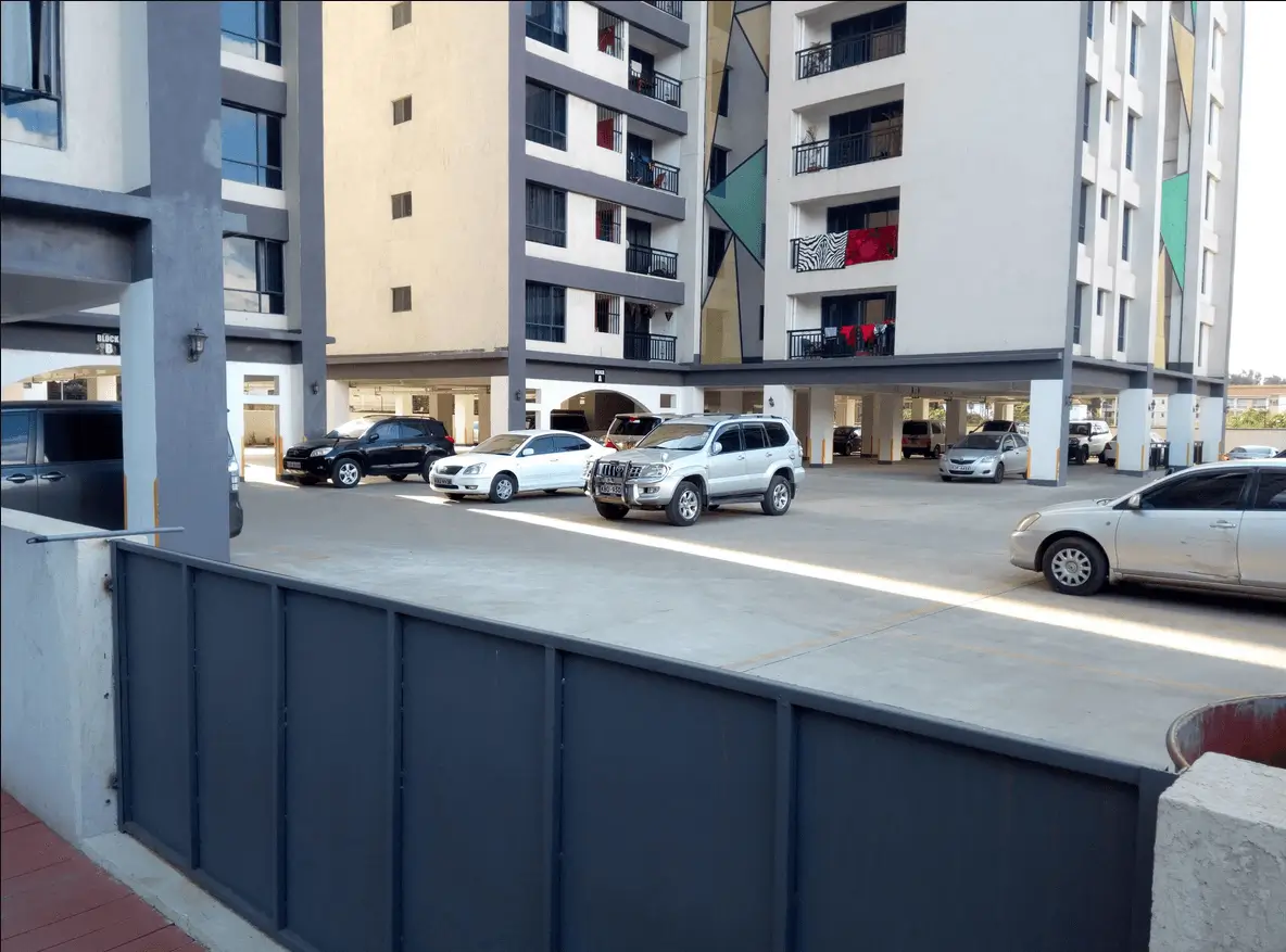 Spacious basement parking with multiple vehicles and residential blocks