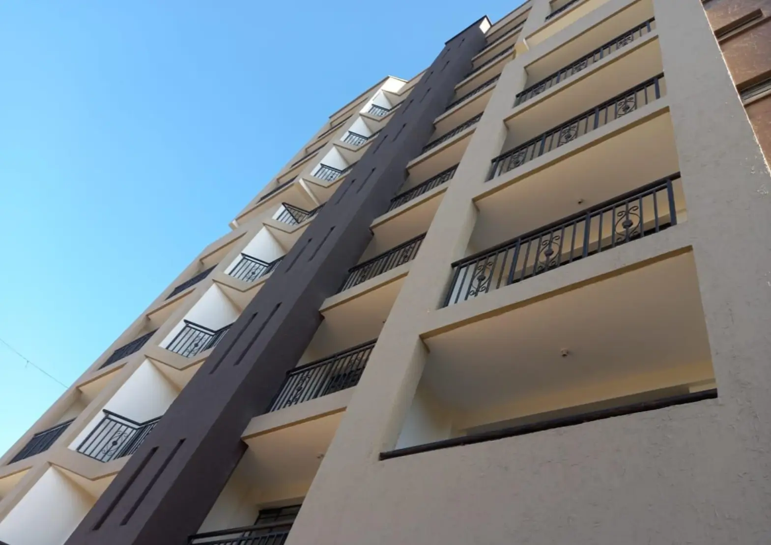 Multi-story residential building facade with balconies and windows
