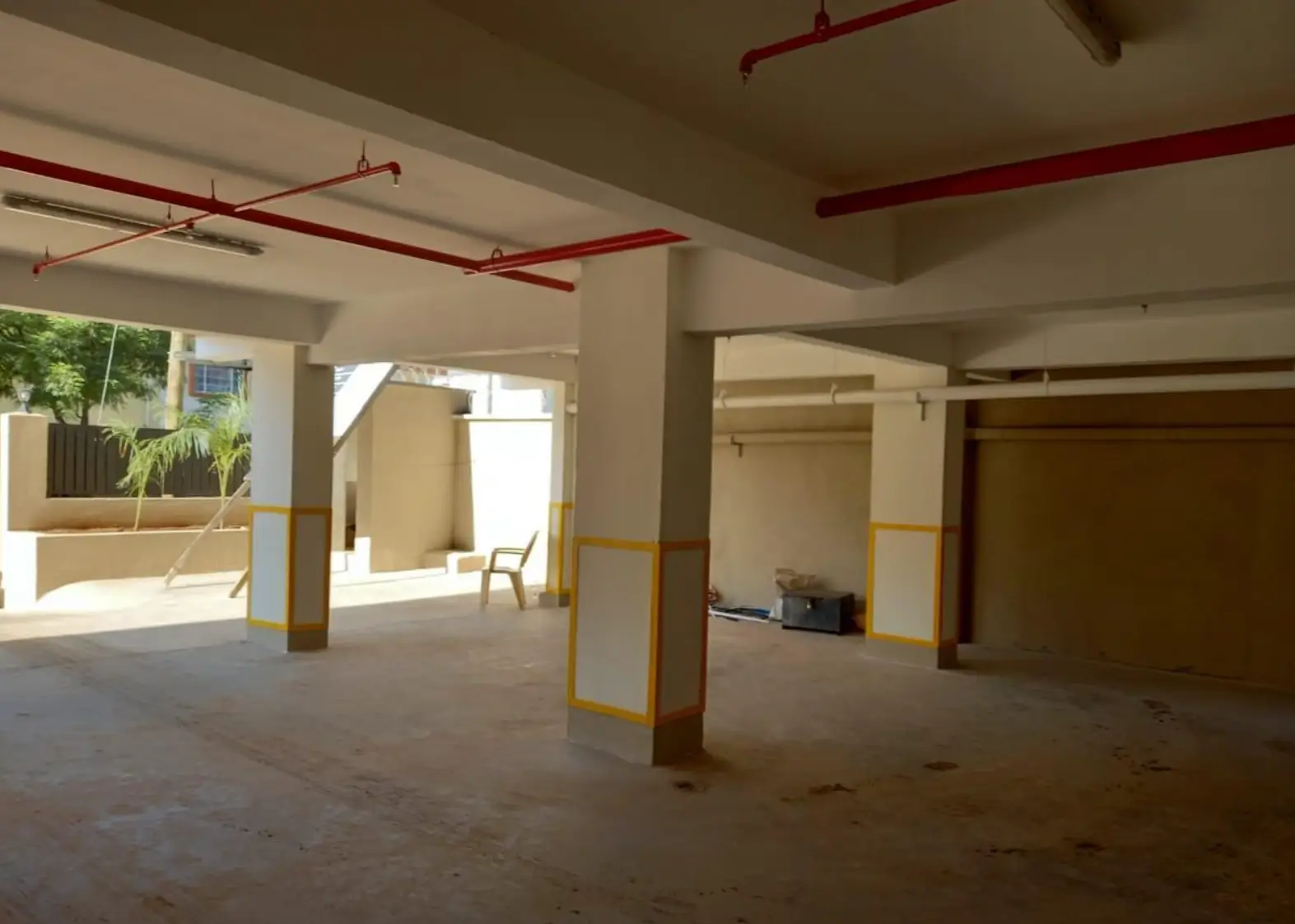 Underground parking garage with support columns and yellow safety markings