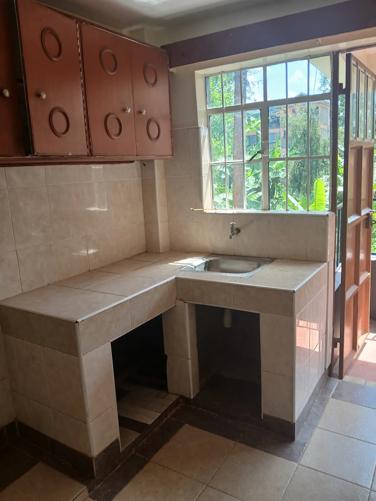 Compact kitchen with L-shaped counter and window views