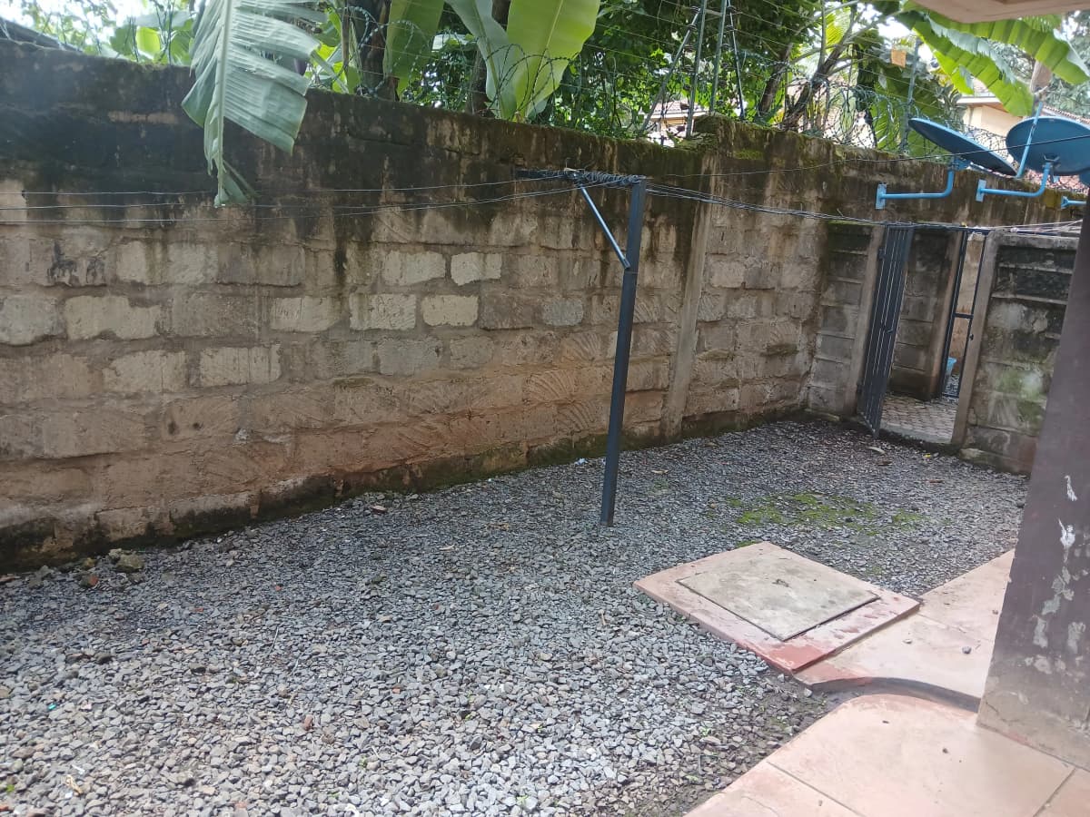 Graveled compound ground with concrete boundary wall