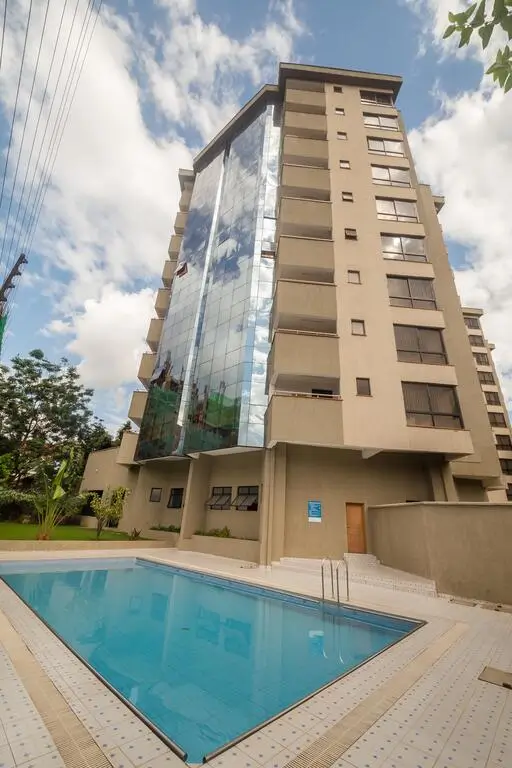 Modern residential building with sparkling swimming pool and landscaped grounds