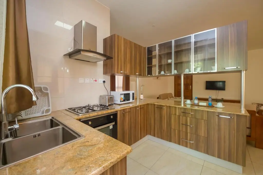 Modern kitchen with wooden cabinets, granite countertops, stainless steel appliances