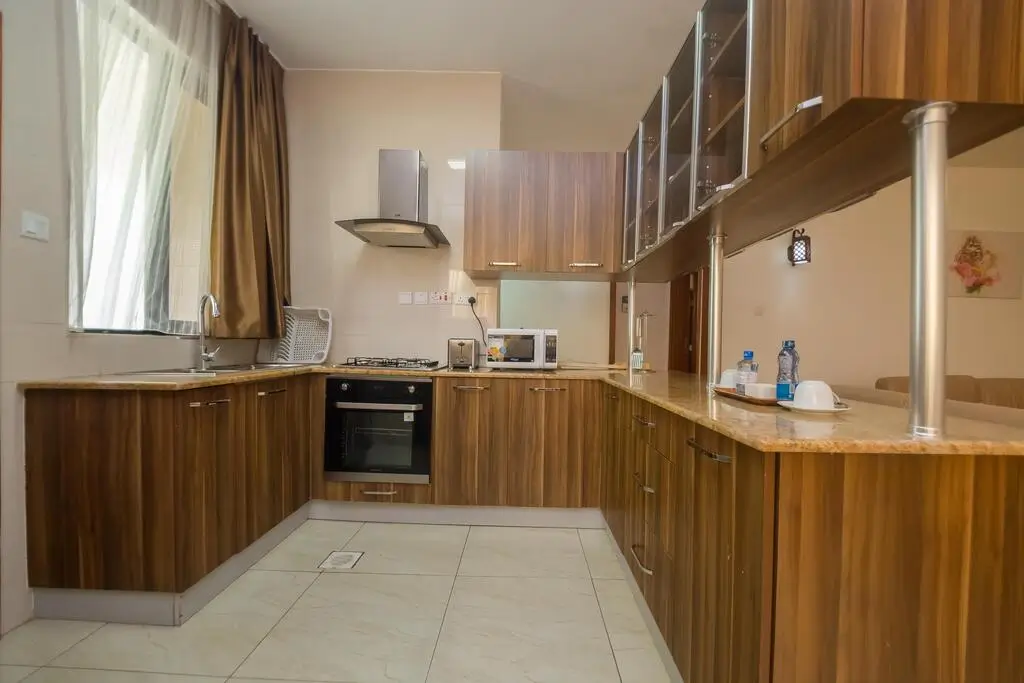 Modern kitchen with wooden cabinetry, gas cooktop, and island counter