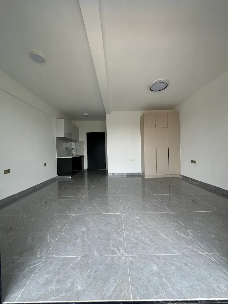 Open-plan living and kitchen space with grey marble flooring