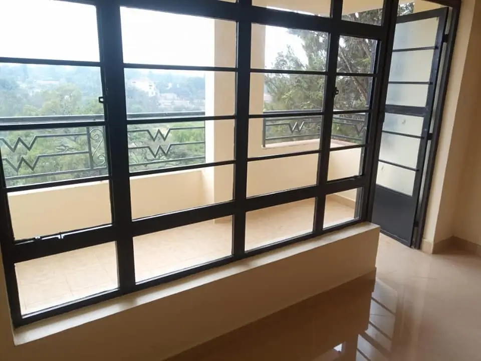 Modern balcony with black-framed glass doors and panoramic outlook