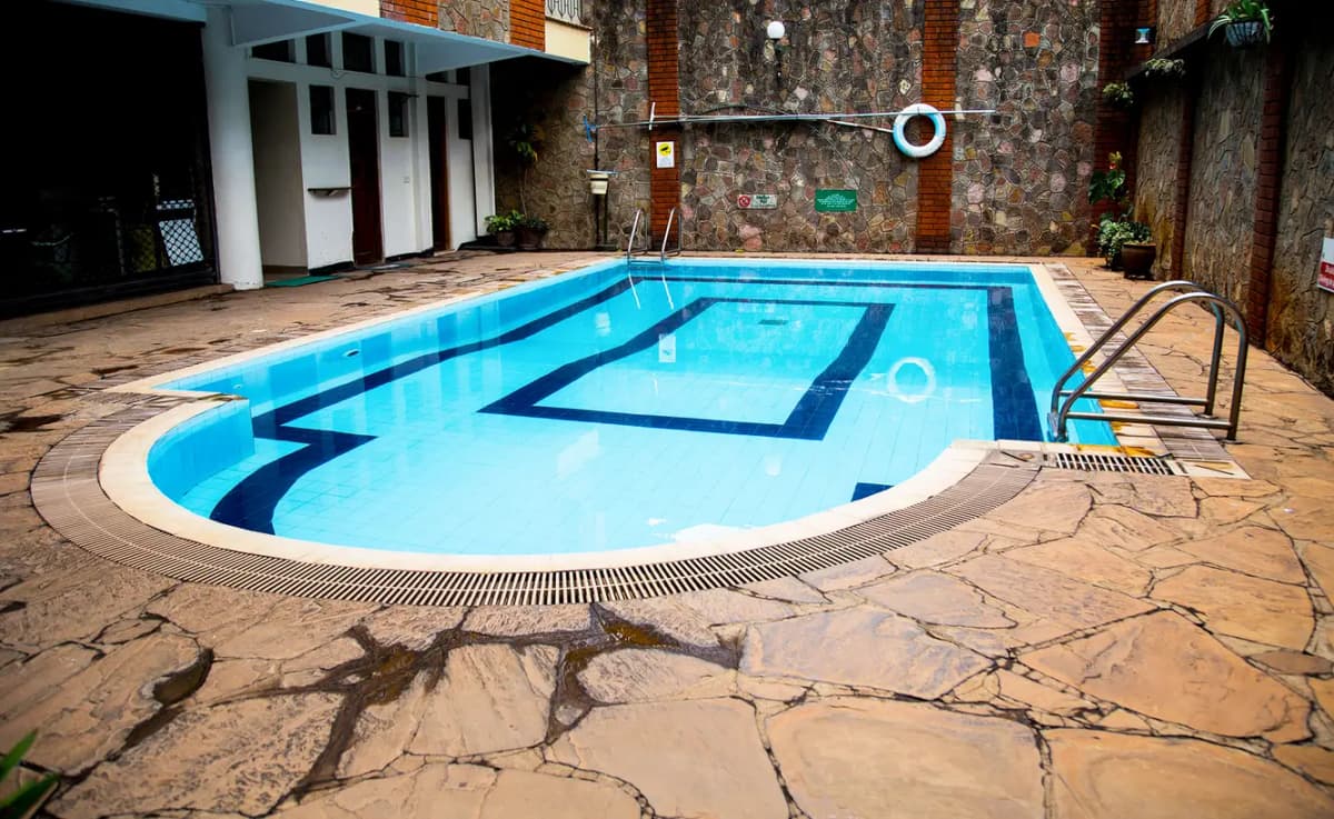 Residential swimming pool with lane markings and metal ladder