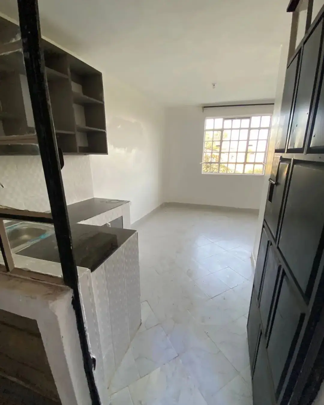 Compact kitchen with built-in counters and storage shelving