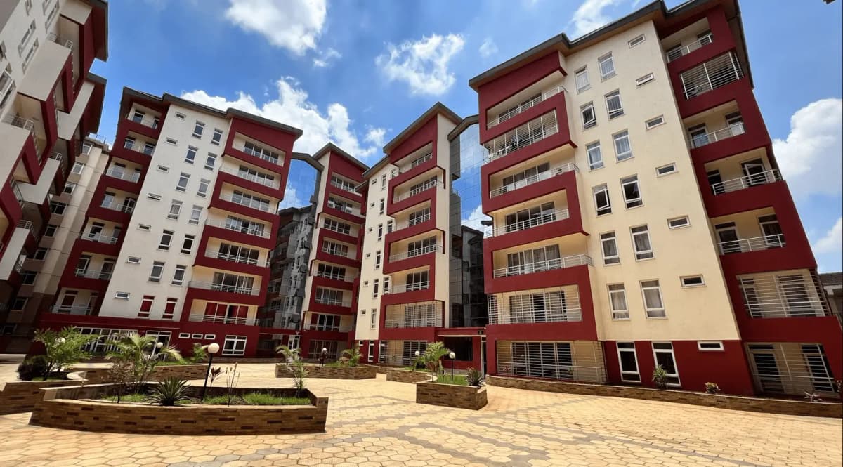 Modern multi-story residential complex with red and cream facade
