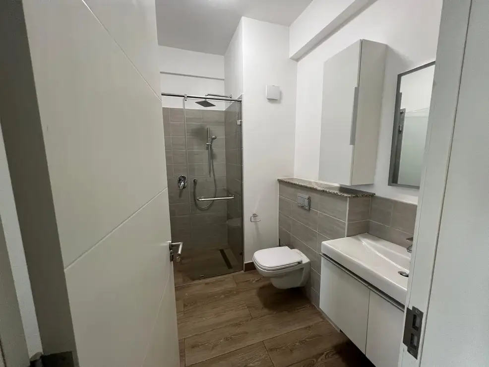 Modern bathroom with walk-in shower and floating vanity