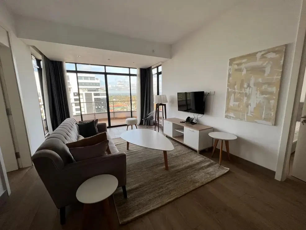 Modern living room with floor-to-ceiling windows, city views