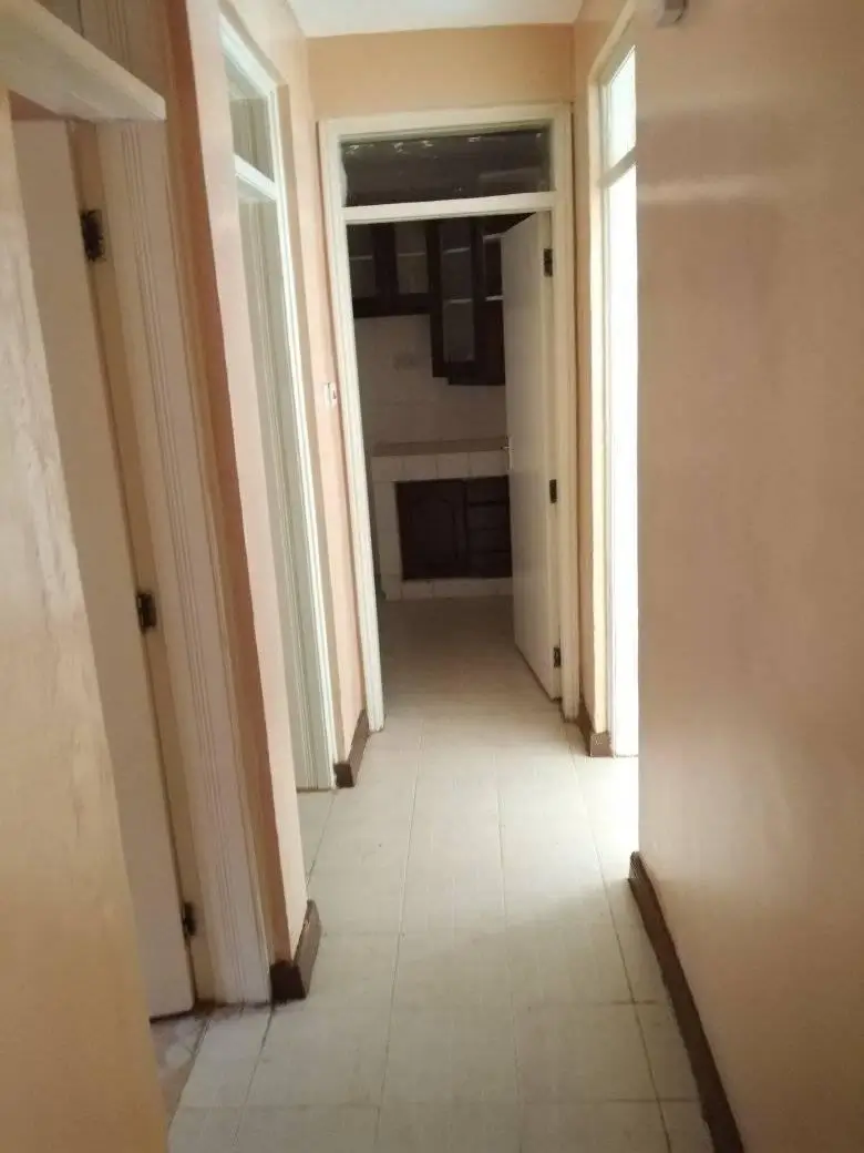 Neutral-toned hallway with white doors leading to rooms