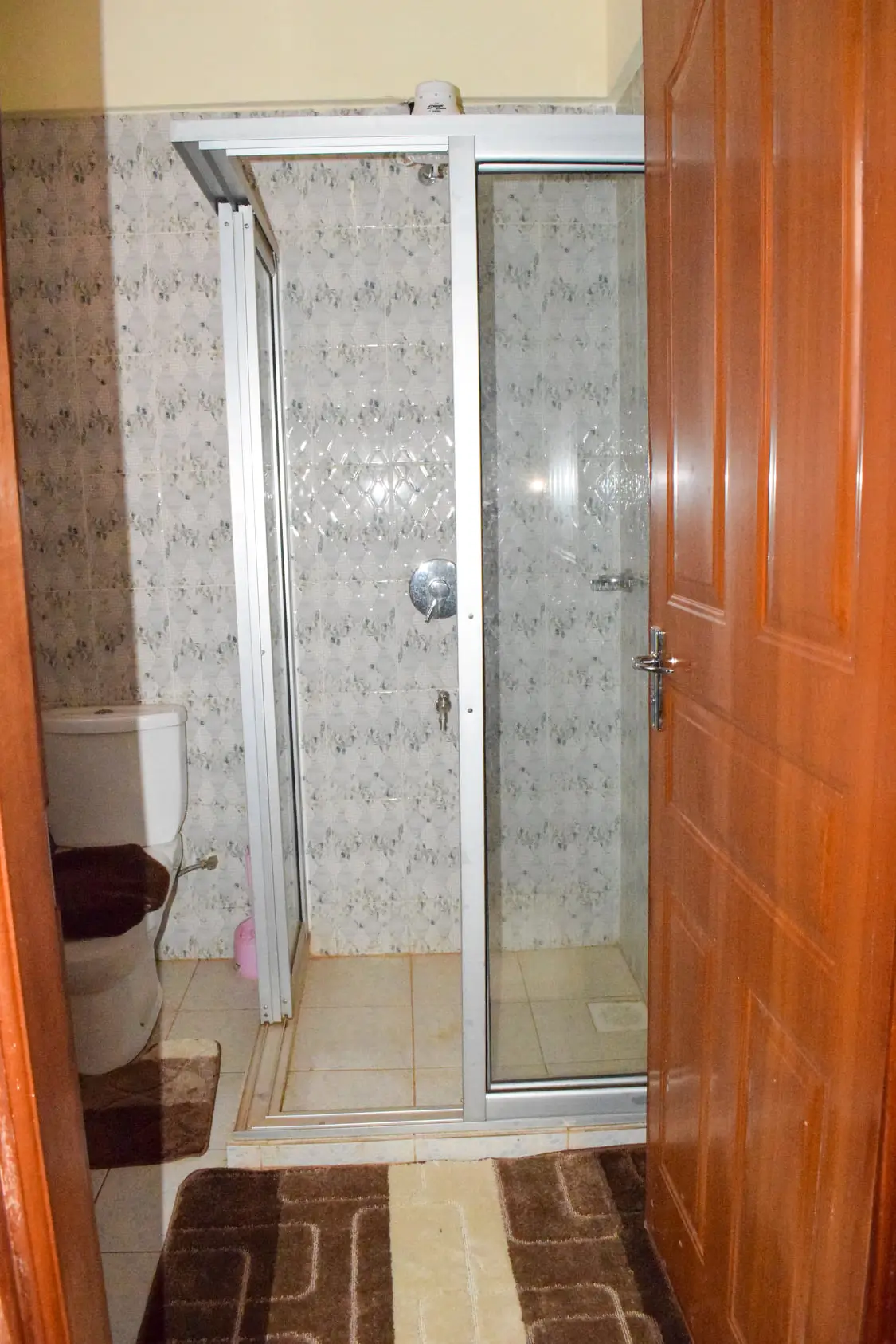 Compact bathroom with enclosed shower cubicle and toilet