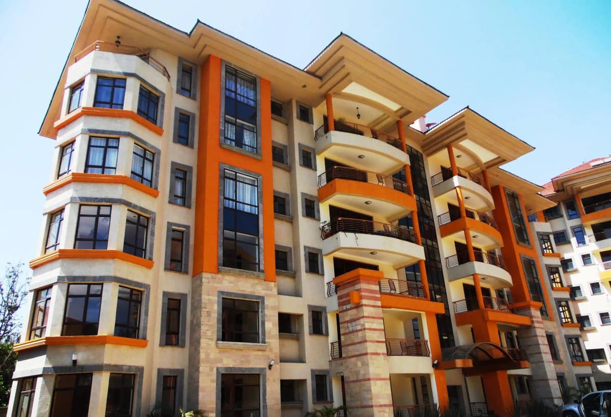 Modern multi-story residential building with orange and cream facade