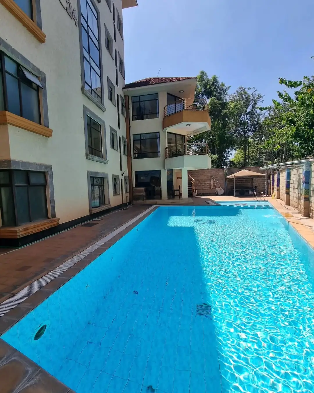 Rectangular swimming pool with clear blue water and surrounding deck