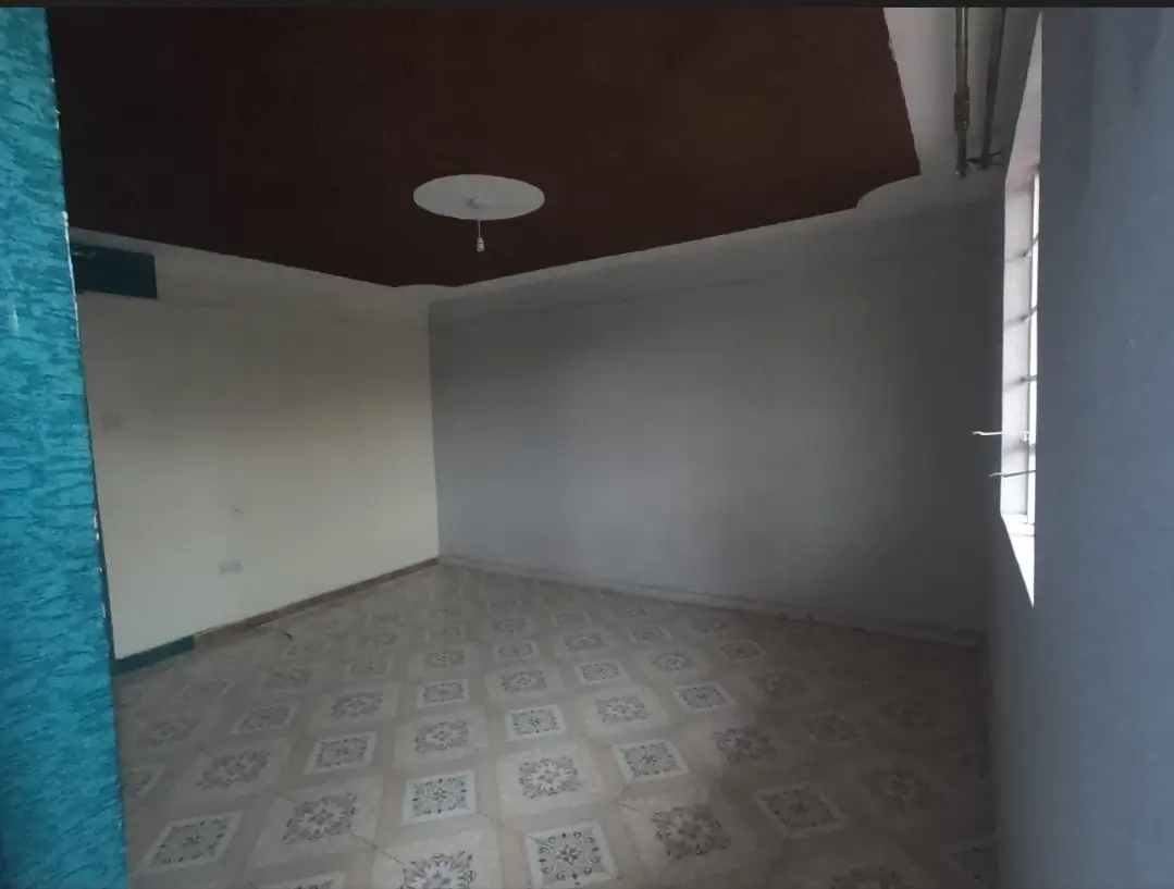 Empty bedroom with patterned tile floor and dark ceiling