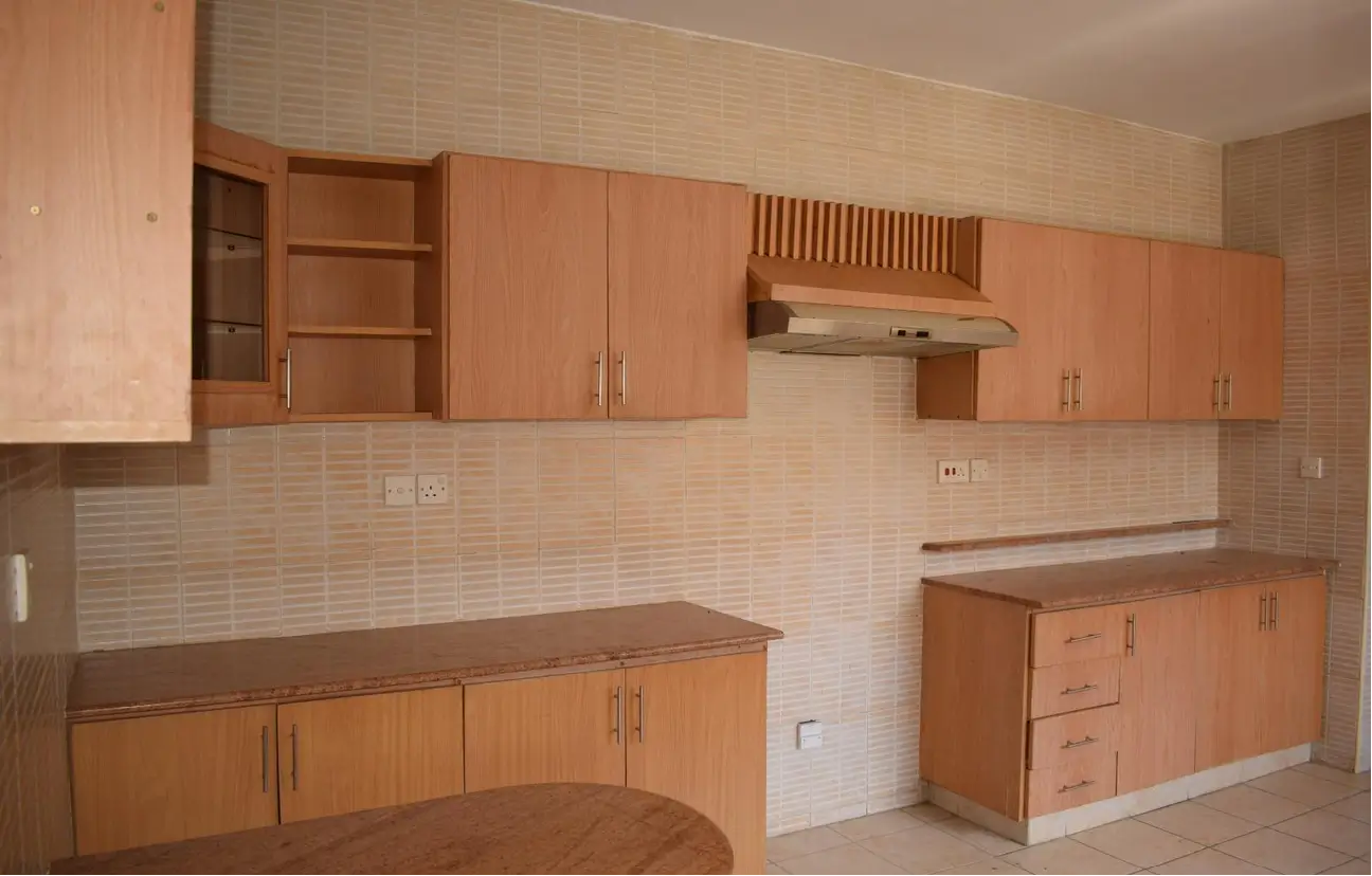 Open-plan kitchen with wooden cabinetry and tiled backsplash