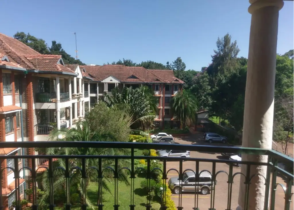 Elevated balcony view overlooking residential compound and gardens
