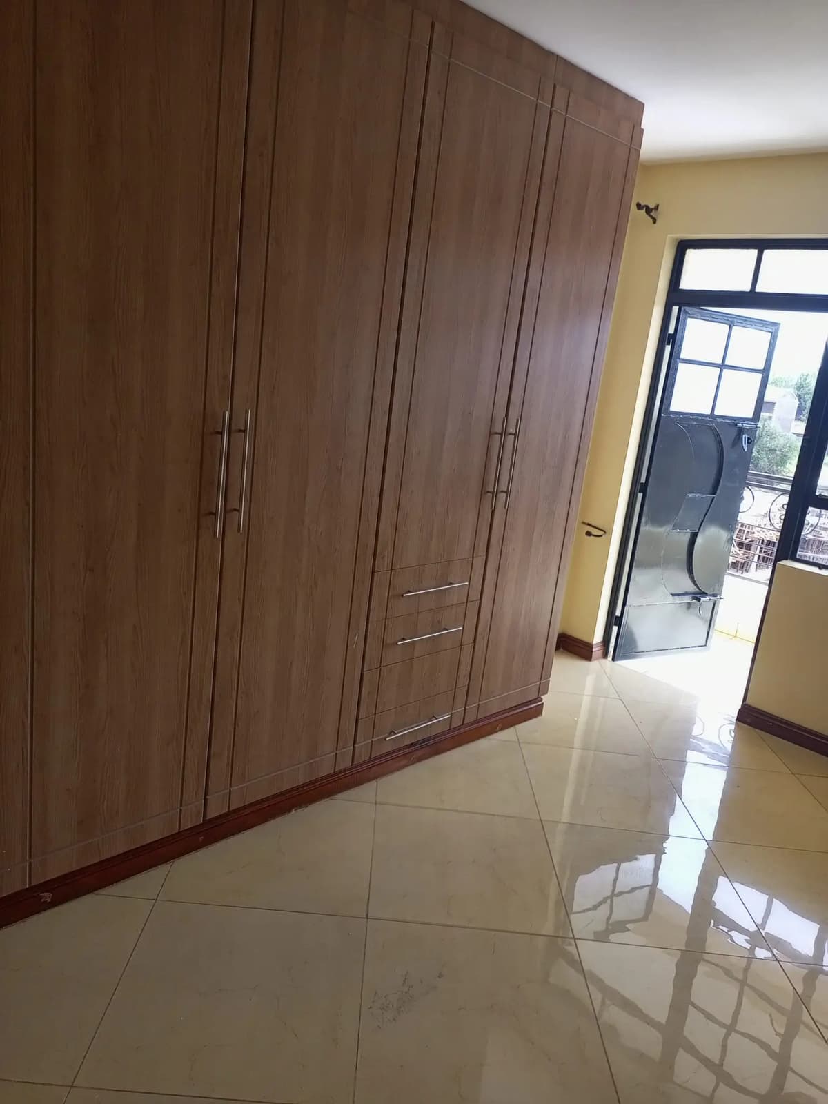Master bedroom with large built-in wooden wardrobe
