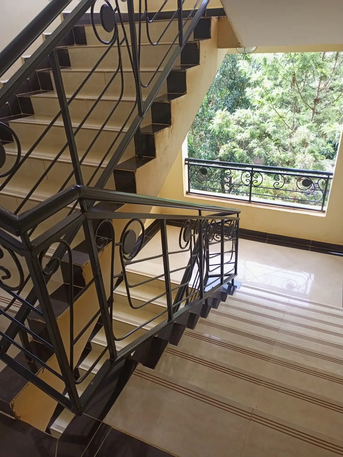 Balcony with ornate railings and tree-lined view