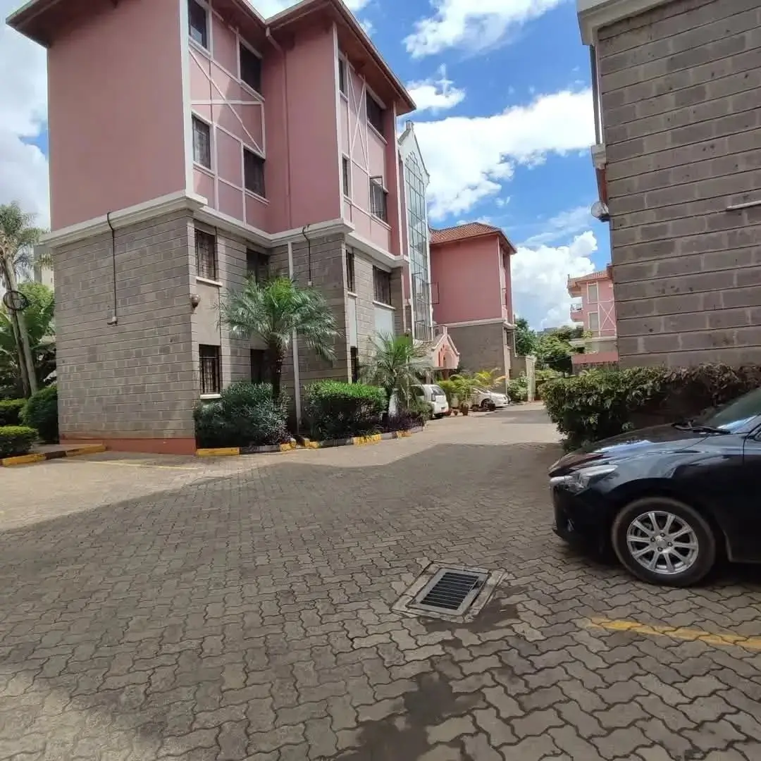 Modern apartment complex with manicured compound and paved driveway