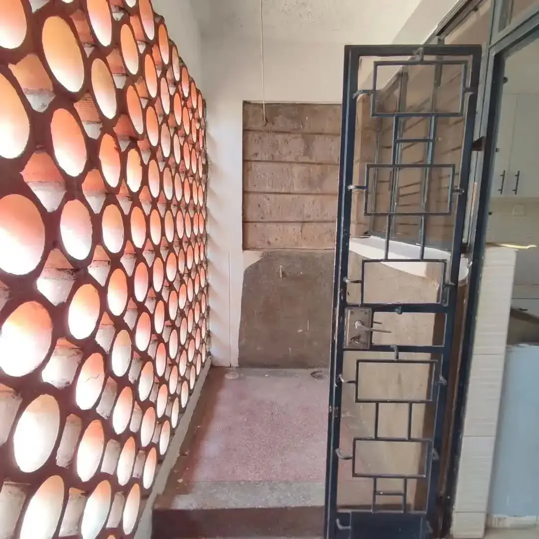 Building corridor with decorative circular wall panels and metal door